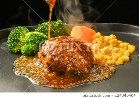Pouring sauce on Japanese-style hamburger steak Pouring sauce on Japanese-style hamburger steak 124340404