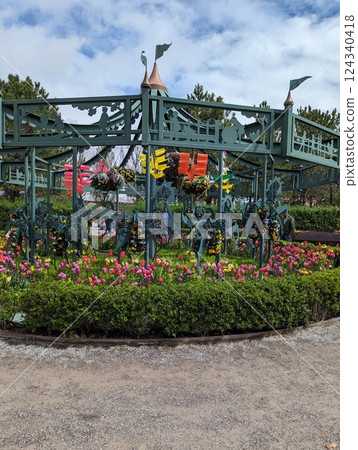 Colorful Garden Carousel Surrounded by Vibrant Tulips and Blooming Flowers 124340418