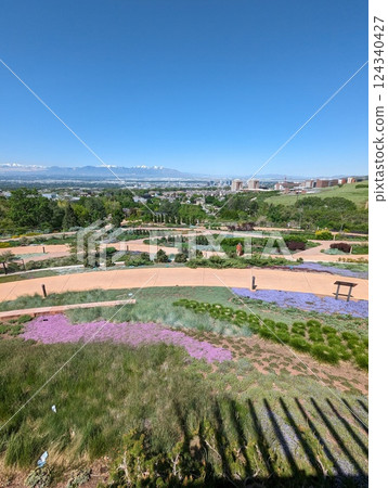 Scenic Garden Path Overlooking Cityscape and Snow-Capped Mountains 124340427