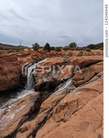 Gunlock Falls Cascading Over Red Rocks in a Stunning Desert Landscape. Gunlock Falls Cascading Over Red Rocks in a Stunning Desert Landscape. 124340444