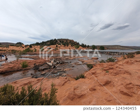 Scenic View of Gunlock Falls with Flowing Water and Red Rock Landscape in Utah. 124340455