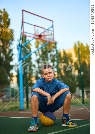 Young tired sporty boy after basketball training 124340891