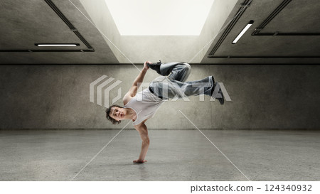 Composite collage. Dancer flying on one hand, holding foot mid-air, body strong and calm, his athletic curves highlighted by light. Concept of movement, music. 124340932