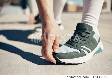 Shoes, hand and stretching with a sports man touching his toes during an exercise or fitness warmup in the city. Health, training and workout with a male athlete getting ready for competition closeup 124341518