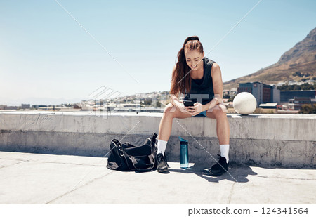 Sports woman, phone and football or soccer workout on city building rooftop for break or rest with 5g network service for app or social media. Female athlete after fitness exercise outdoor with ball Sports woman, phone and football or soccer workout on city building rooftop for break or rest with 5g network service for app or social media. Female athlete after fitness exercise outdoor with ball 124341564