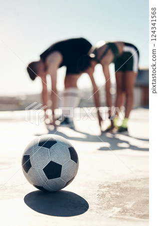 Soccer, stretching and people training in the city for professional event, competition and game. Athlete friends doing a warm up, cardio exercise and workout for football sport together on the ground 124341568