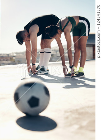 Athletes stretching, soccer player and couple workout on rooftop for sports fitness exercise in summer sun. Urban sports, football player training and stretch together for cardio health cityscape run 124341570
