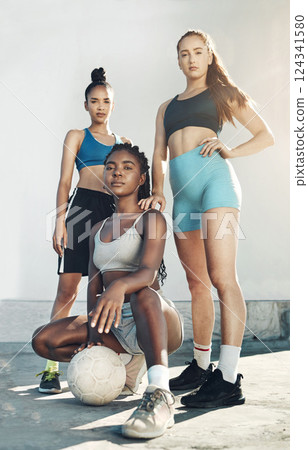 Team sports, football and portrait of friends standing together with ball on city court outdoors. Woman diversity, sport fitness health and girlfriends empowerment or support before competition match Team sports, football and portrait of friends standing together with ball on city court outdoors. Woman diversity, sport fitness health and girlfriends empowerment or support before competition match 124341580