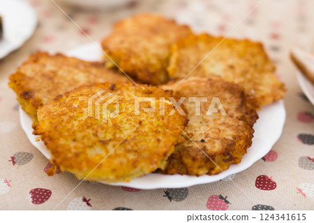 Potato pancakes with sour cream on white plate 124341615