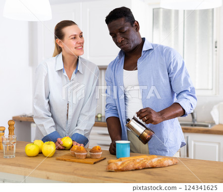 Husband and wife having breakfast together at home 124341625