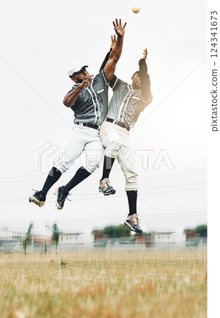 Sports, baseball and men jump to catch ball on field during game, action and motion with teamwork. Fitness, baseball team and black man jumping with teammate to help with catching for strike out. Sports, baseball and men jump to catch ball on field during game, action and motion with teamwork. Fitness, baseball team and black man jumping with teammate to help with catching for strike out. 124341673