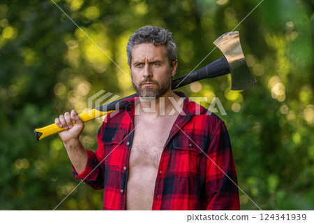 Hispanic lumberjack man with axe. Lumberjack axe. Man with logging axe. Hardworking brutal man. Lumberjack hardworking outdoor. Brutal lumberjack. Brutality and masculinity. Woodcutter portrait 124341939