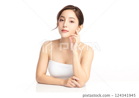 A beautiful young Asian woman with clean, fresh skin against a white background. Skincare, facial treatment, cosmetology, beauty, and spa. An elegant portrait of an Asian woman. A beautiful young Asian woman with clean, fresh skin against a white background. Skincare, facial treatment, cosmetology, beauty, and spa. An elegant portrait of an Asian woman. 124341945