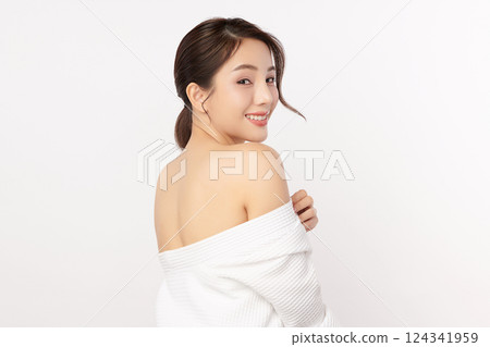 A beautiful young Asian woman with clean, fresh skin against a white background. Skincare, facial treatment, cosmetology, beauty, and spa. An elegant portrait of an Asian woman. 124341959