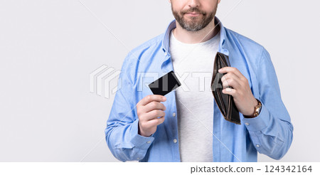 man with payment card and wallet isolated on studio background, cropped view. man with payment card and wallet isolated on studio background, cropped view. 124342164