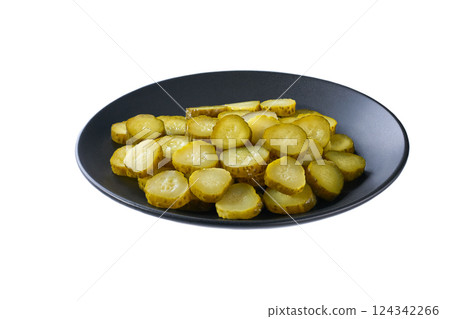 chopped pickled cucumbers in a black plate isolated on a white background. 124342266
