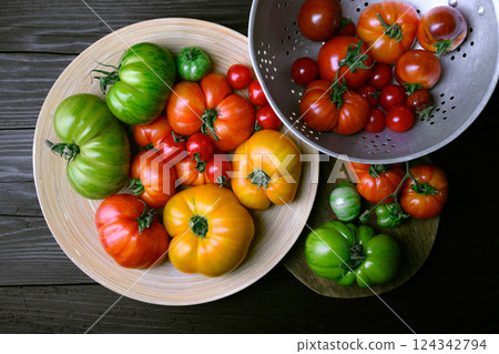 Mix of different sizes and colors tomatoes on rustic wooden table Mix of different sizes and colors tomatoes on rustic wooden table 124342794