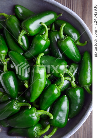 Top view on metal colander filled with green jalapeno peppers 124342930