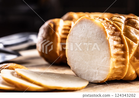 Oscypki - Traditional salty smoked cheese made from sheep's milk from the Polish region of Zakopane under the High Tatras - close up 124343202