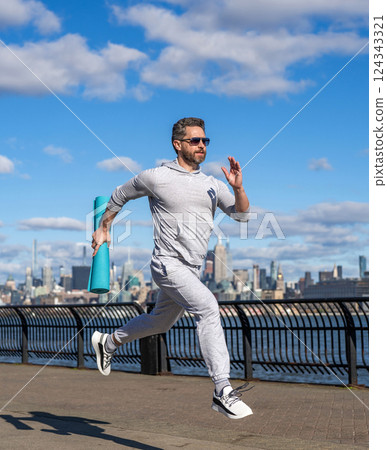 Sportsman jogger running. Morning sport workout runner running. Sport runner in Manhattan. Sportsman in New York. Man sportsman running for exercise in active wear. Sport training 124343321