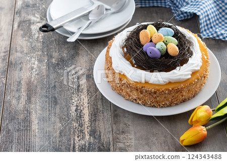 Homemade Easter egg cake on wooden table Homemade Easter egg cake on wooden table 124343488