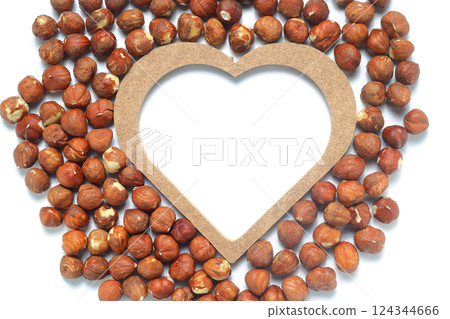 Heart shape made of nuts. Brown hazelnut kernels on a white background Heart shape made of nuts. Brown hazelnut kernels on a white background 124344666