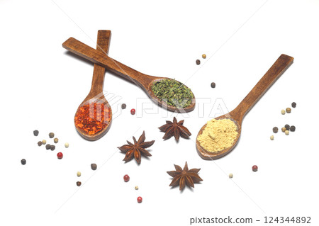 Different kind of spices on a white background. Oriental spices in spoons, red peppers, curry powder, cinnamon powder, mint powder, colorful peppers. Flat lay, top view. 124344892