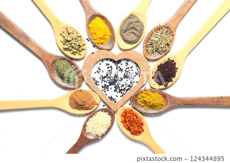 Different kind of spices on a white background. Oriental spices in spoons, red peppers, curry powder, cinnamon powder, mint powder, sumac, sesame, black cumin, Different kind of spices on a white background. Oriental spices in spoons, red peppers, curry powder, cinnamon powder, mint powder, sumac, sesame, black cumin, 124344895