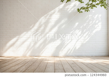 Minimalistic light background with blurred foliage shadow on white brick wall 124344960