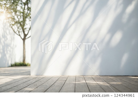 Minimalistic light background with blurred foliage shadow on white wall 124344961