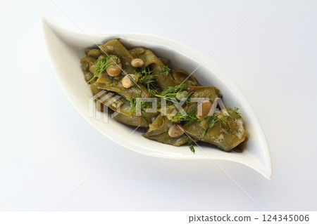 Broad bean and dill in the white plate with white background. 124345006