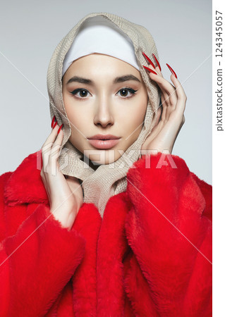 beautiful young woman in hijab and red fur. beauty stylish girl with long Nails 124345057
