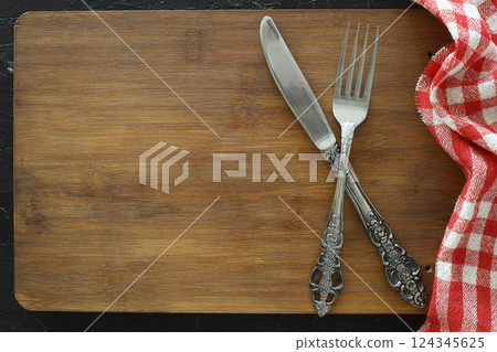 Overhead shot of silverware on black table with copy space. Overhead shot of silverware on black table with copy space. 124345625
