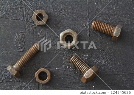 Metal dowel nail with a plastic box on a black background Metal dowel nail with a plastic box on a black background 124345626