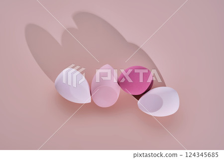 A set of makeup sponges on a pink background. A set of makeup sponges on a pink background. 124345685