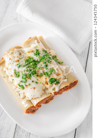 Oven-Baked Cannelloni Stuffed with Savory Bolognese and Covered in Golden Mozzarella Oven-Baked Cannelloni Stuffed with Savory Bolognese and Covered in Golden Mozzarella 124345750
