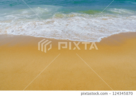 Stunning Sandy Beach with Gentle Waves and Clear Blue Sky Perfect for Relaxation and Fun Activities Stunning Sandy Beach with Gentle Waves and Clear Blue Sky Perfect for Relaxation and Fun Activities 124345870