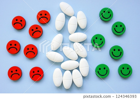 Antidepressants between happy and sad emojis. Mental health treatment. 124346393