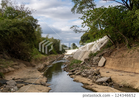 The riverbank of Ylang Ylang River in Cavite, Philippines at a low water level The riverbank of Ylang Ylang River in Cavite, Philippines at a low water level 124346652