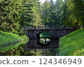 Old bridge in the park. Sunny weather. Warm summer day. 124346949
