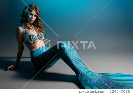 Woman poses as a mermaid in dazzling body art for cosplay event Woman poses as a mermaid in dazzling body art for cosplay event 124347086