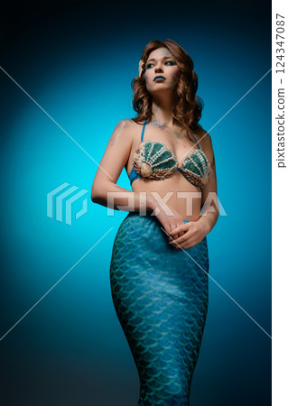 Mermaid cosplay with body art showcasing vibrant colors and intricate details 124347087