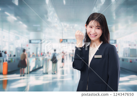 A young female staff member giving directions at the station 124347650