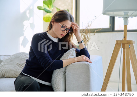 Mature sad woman experiencing stress, mental and physical pain, at home 124348790