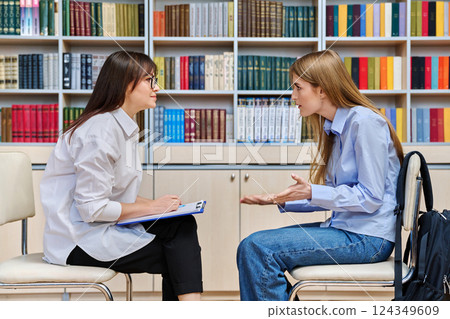Female psychologist, teacher, social worker, mentor working with teenage girl Female psychologist, teacher, social worker, mentor working with teenage girl 124349609