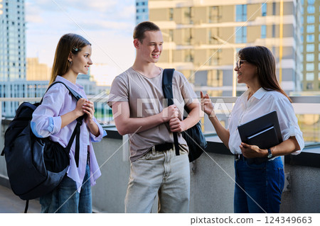 Group of college students talking with female teacher Group of college students talking with female teacher 124349663