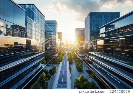Modern glass skyscrapers reflecting setting sun at business district with solar panels 124350069
