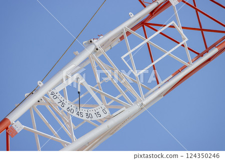 Close-up of a climbing crane move. Image of a construction site Close-up of a climbing crane move. Image of a construction site 124350246