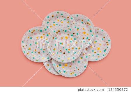 A set of white paper plates with patterns, colored pink and green circles and golden stars. 124350272