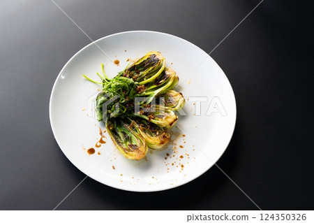 Fresh bok choy boasts vibrant greens and rich sauces, highlighting Asian culinary art. Fresh bok choy boasts vibrant greens and rich sauces, highlighting Asian culinary art. 124350326